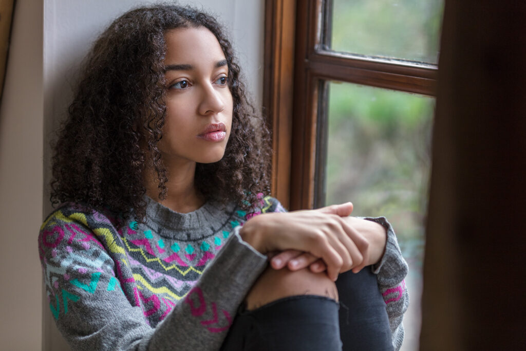 teen looking out the window