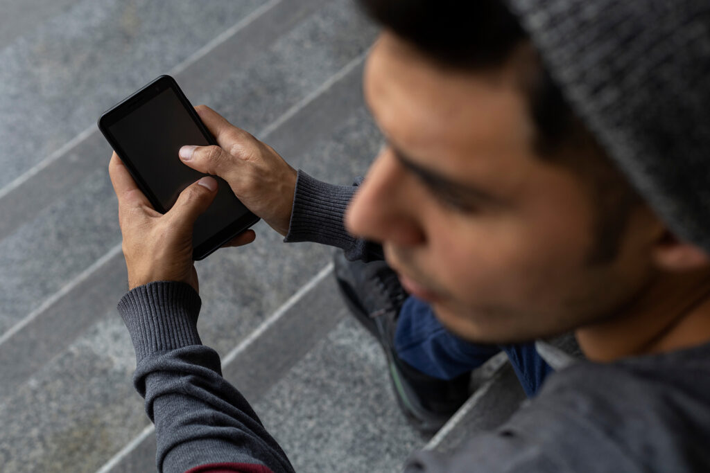 latino teen holding phone