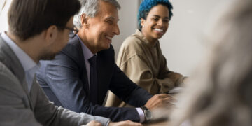 youn person at meeting with older professionals