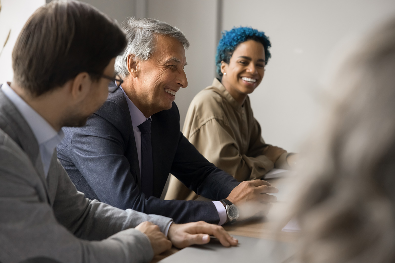 youn person at meeting with older professionals