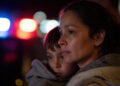 mother holding young son during an ICE raid