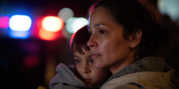 mother holding young son during an ICE raid